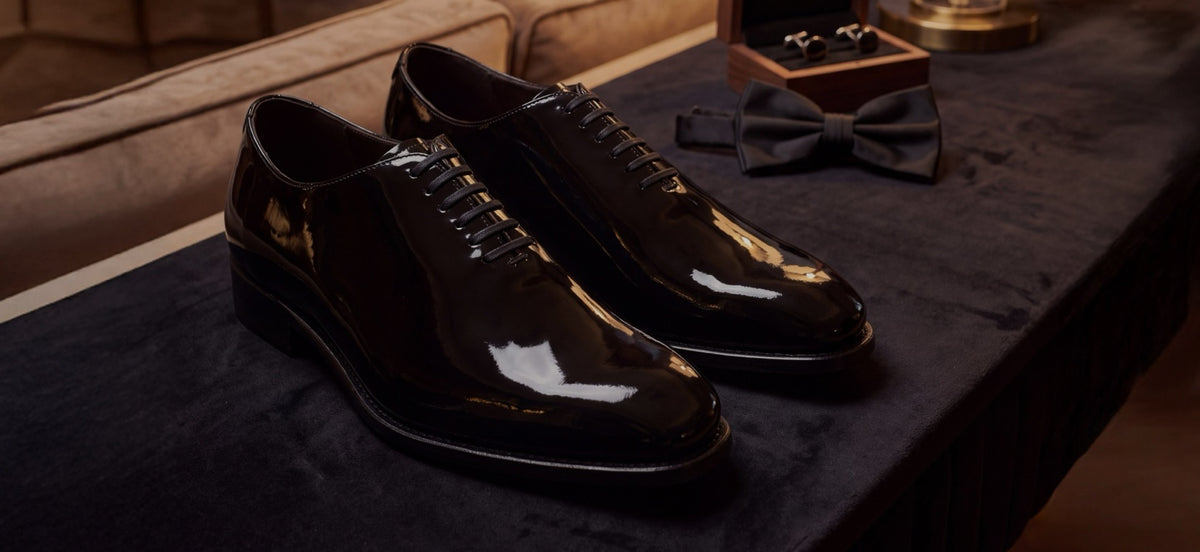 Black patent wholecut oxfords with a black bow tie and cufflinks, ready for a black tie wedding